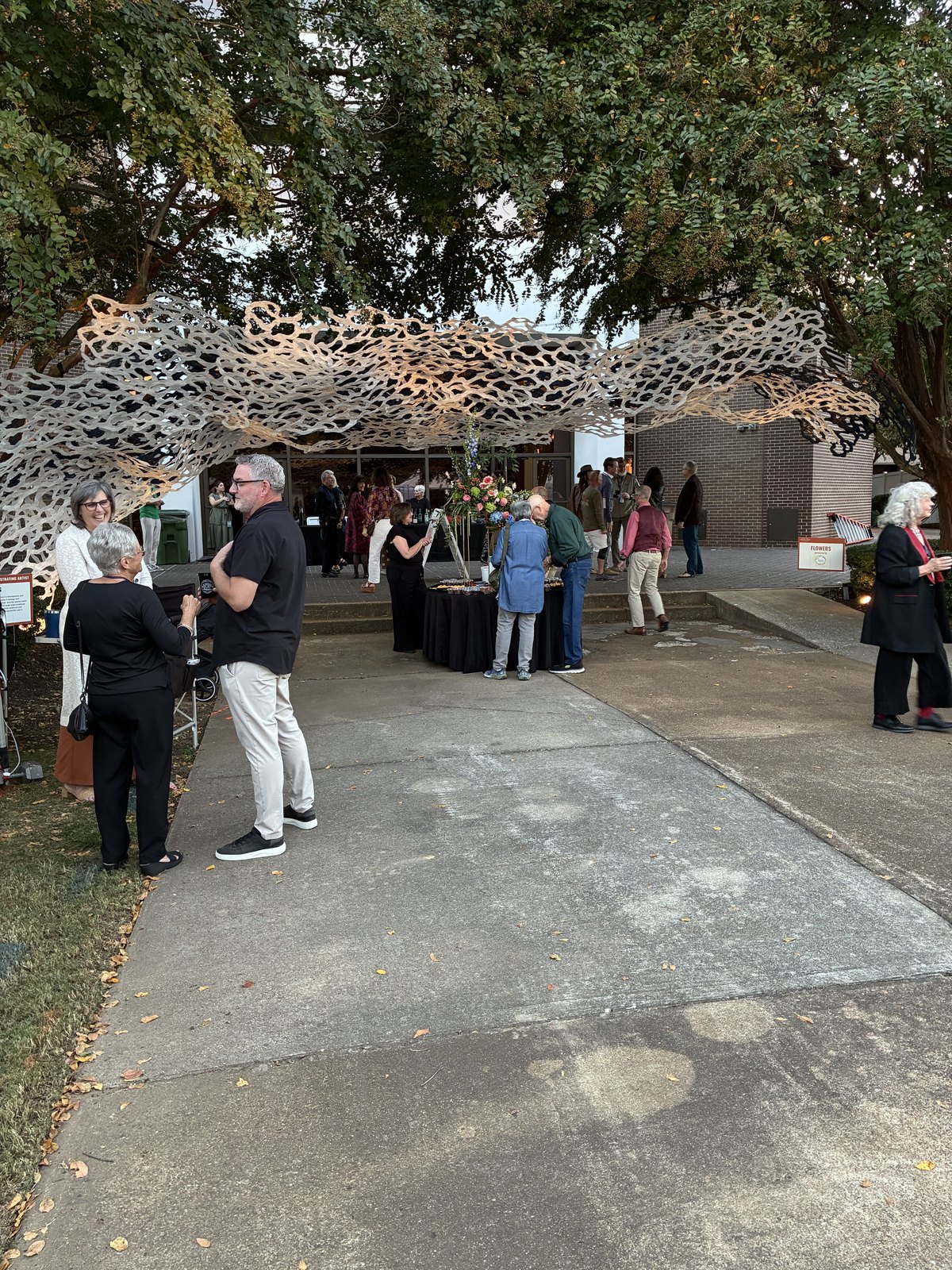 Guests gather beneath a decorative canopy during River Clay’s opening evening