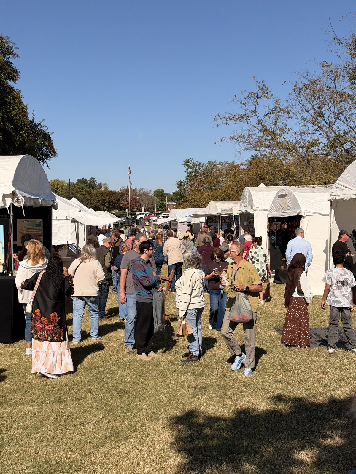 Visitors browse the outdoor artist market at River Clay 2026 in downtown Decatur